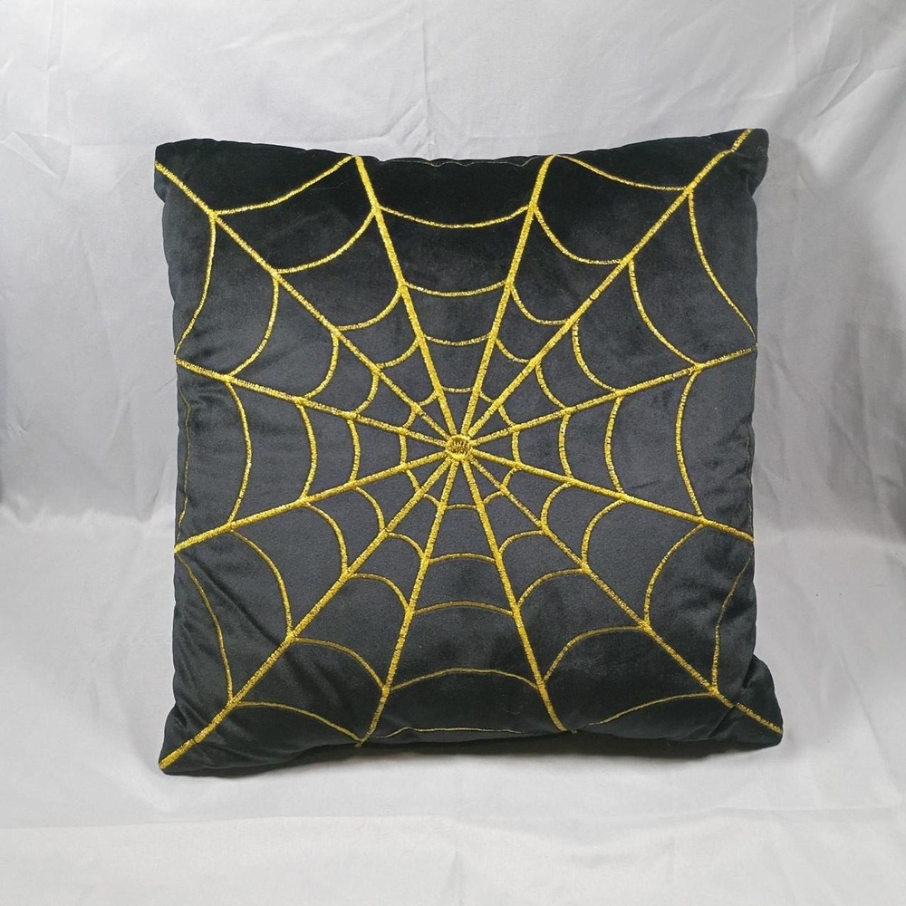 Black velvet pillow with gold spiderweb embroidery